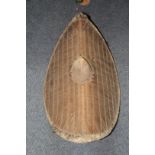 African: a Ugandan shield of eliptical canted form with central boss and canework, 63.5cm, (a.