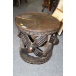 African: a wooden Cameroon Bamileke stool carved with spider motif, 41cm diameter.