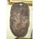 African: a small hide shield, having rectangular blocks of punched decoration, approx 78.5cm long.