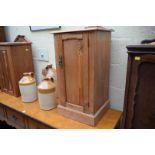 An old pitch pine bedside cupboard, 40.5cm wide; together with another walnut example.