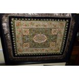 A Burmese silk and metal thread embroidered rug; decorated with semi precious gem stones,