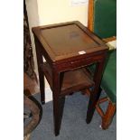 A Chinese hardwood two tier stand or table, with small lateral frieze drawer, 39cm wide.
