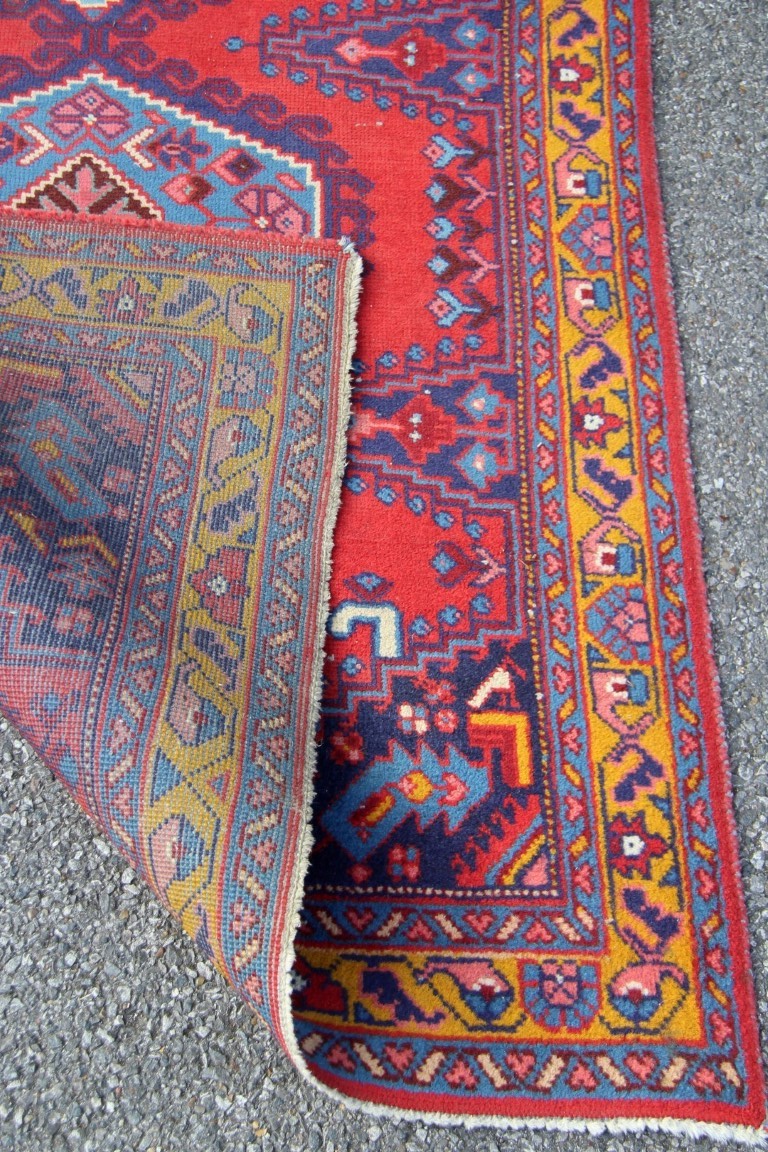 A North West Persian triple medallion rug on a red field, 151 x 105cm. - Image 16 of 16