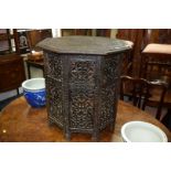 A carved and pierced hardwood octagonal occasional table, 58.5cm wide.