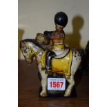 A clockwork tinplate horse mounted drummer, 14.5cm high.