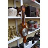 A mahogany and inlaid wheel barometer, by Comitti.