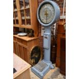 A vintage pale blue enameled Avery 'Penny in Slot' weighing machine, 183cm high.