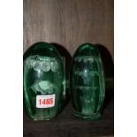 Two old green glass dump paperweights, 13cm high.