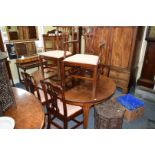 A set of six George III mahogany dining chairs, including an elbow chair.