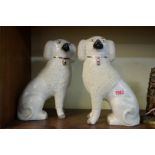 A pair of 'Old Staffordshire Ware' poodles, 26cm high, (repair to leg of one).