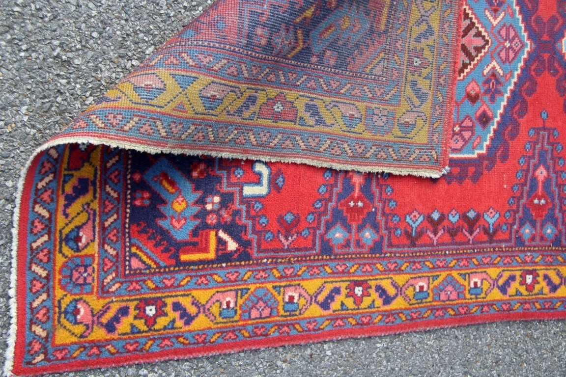 A North West Persian triple medallion rug on a red field, 151 x 105cm. - Image 15 of 16