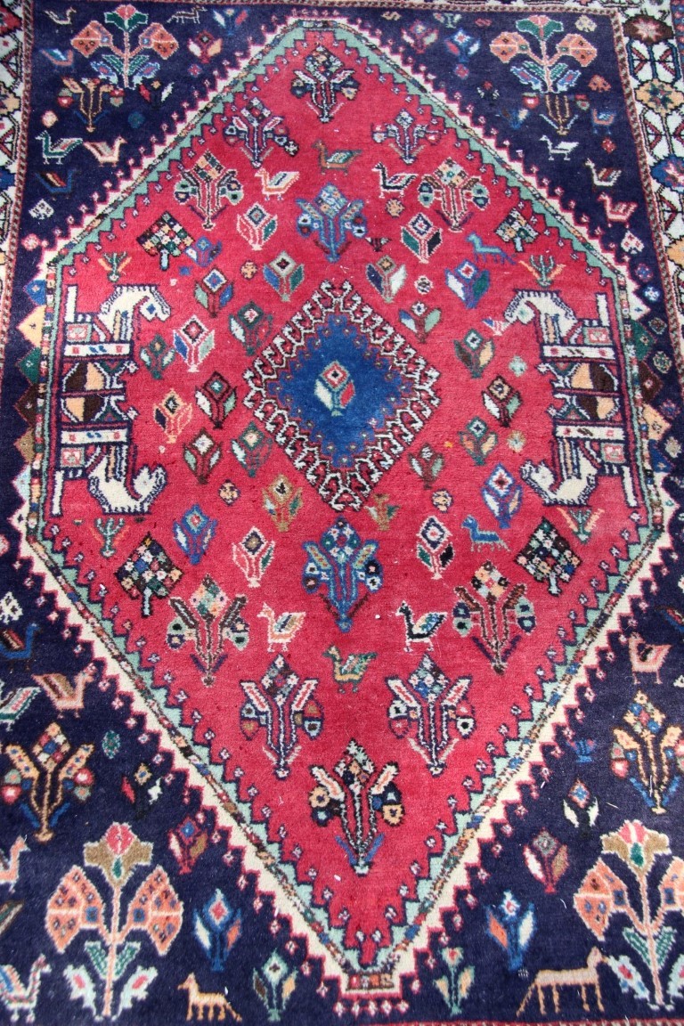 A Persian Qashgai rug, with central medallion and stylised flowers, birds and four horse heads, - Image 12 of 16