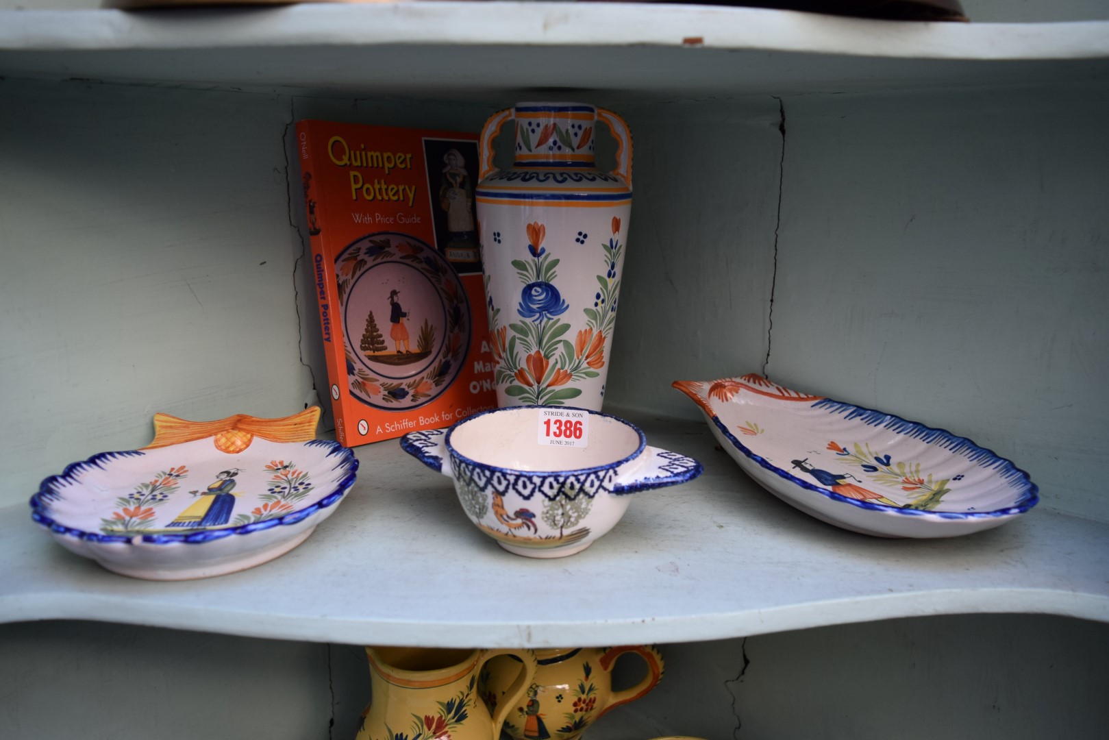 *WITHDRAWN FROM SALE*A collection of ten items of Quimper ware pottery, together with price guide.