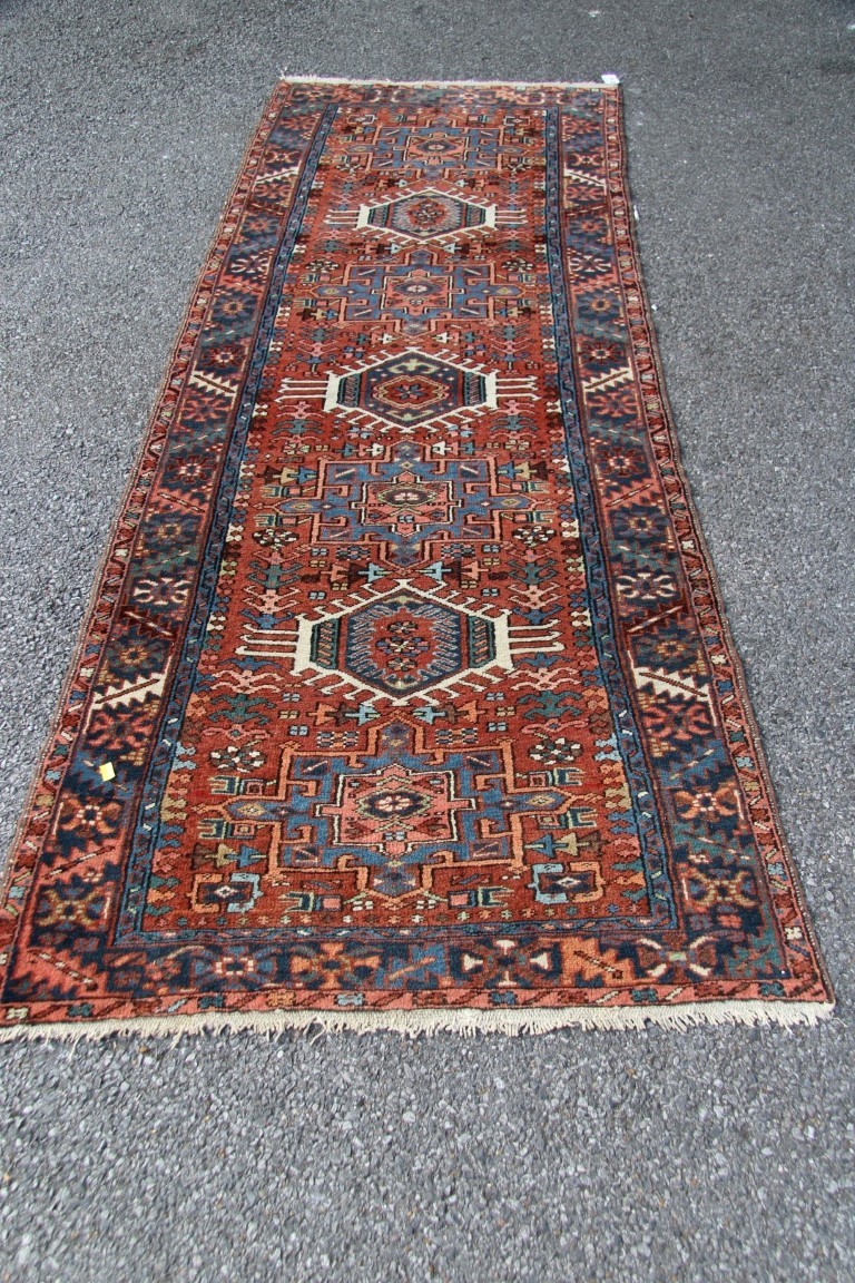 A North West Persian Karaja runner, with seven medallions on a geometric design red field, - Image 3 of 18