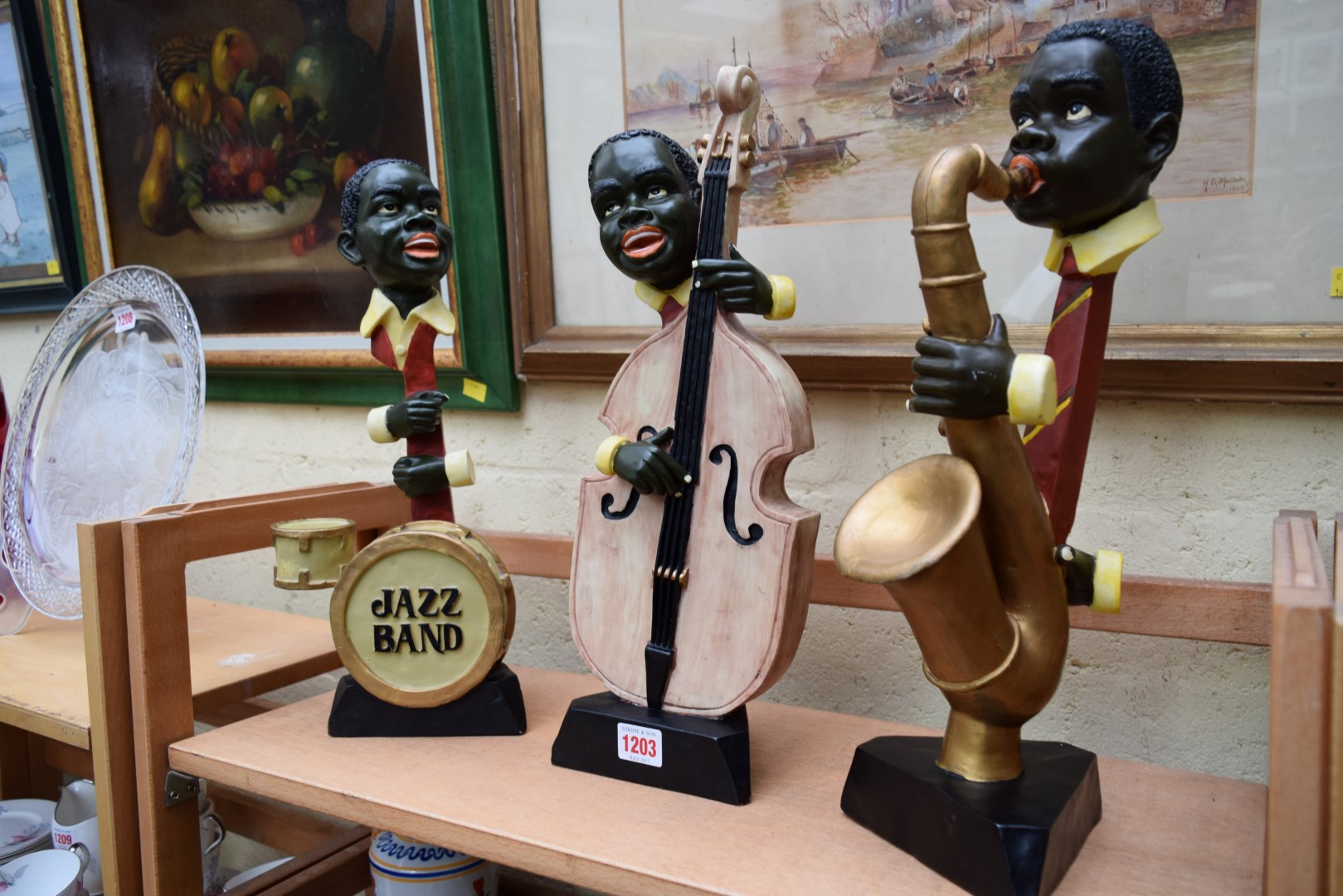 Three resin jazz age style figures of musicians, 41.5cm high.