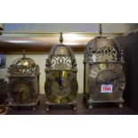 Three battery operated brass lantern clocks, largest 25cm high.