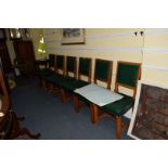 A set of six Victorian Gothic oak and green leather dining chairs, labelled 'Edwards & Roberts'.