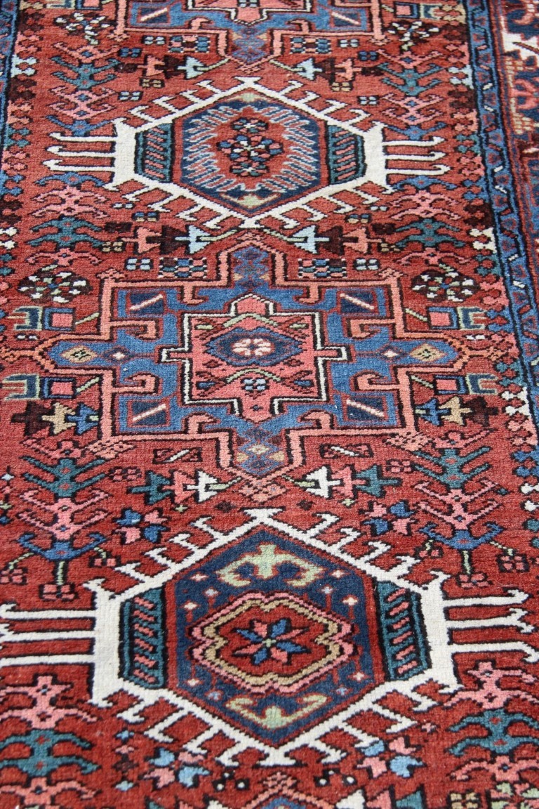 A North West Persian Karaja runner, with seven medallions on a geometric design red field, - Image 12 of 18