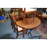 A late Victorian mahogany and satinwood strung extending dining table, with two leaf insertions,