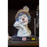 A Lladro bust of a clown, titled 'Melancholy', with stand and boxed.