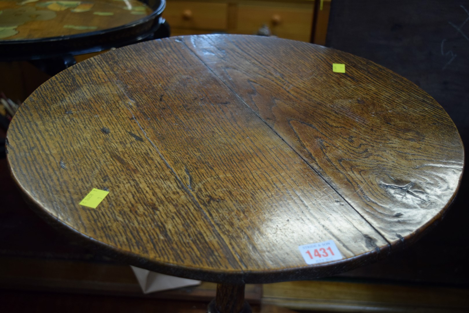 A George III oak circular tilt-top tripod table, 50cm diameter.