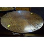 A George III oak circular tilt-top tripod table, 50cm diameter.