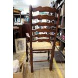 A set of seven beech and rush ladderback dining chairs,