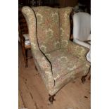 An 18th century style wing armchair.