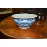 A Chinese blue and white bowl or basin, Qing Dynasty, painted with stylized dragons, 28cm diameter.