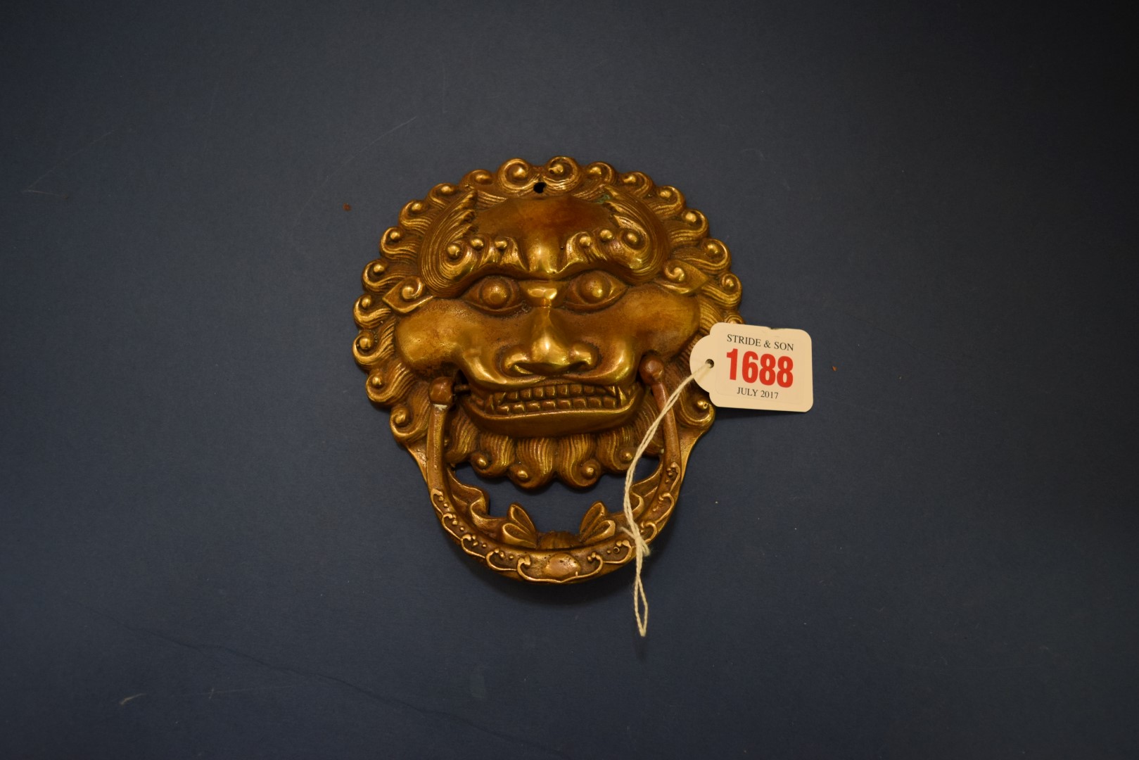 A Chinese gilt bronze lion mask door knocker, 13.5cm wide.