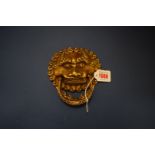 A Chinese gilt bronze lion mask door knocker, 13.5cm wide.