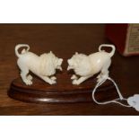 *WITHDRAWN FROM SALE* An ivory figure group of two lions, on wood stand, 11cm wide.