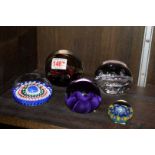 Five glass paperweights,