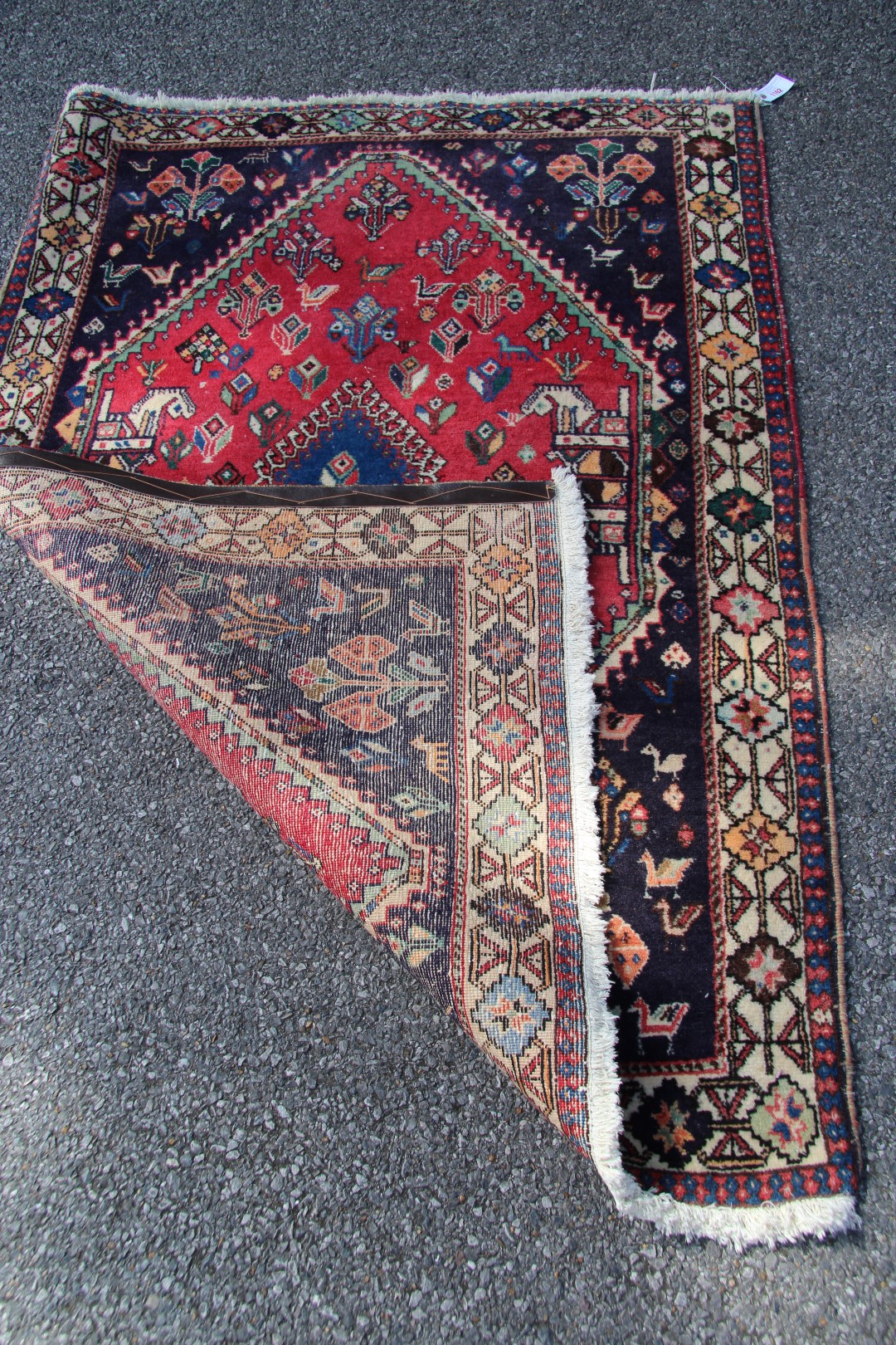 A Persian Qashgai rug, with central medallion and stylised flowers, birds and four horse heads, - Image 13 of 16