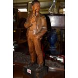 An early 20th century Black Forest carved wood figure of a man with a pipe, 48cm high.