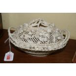 A Belleek pierced twin handled basket and cover, 21cm wide, (damage).