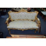 A Louis XV style carved giltwood and damask settee, 145cm wide.
