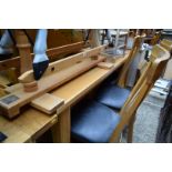 A contemporary pale oak dining table and six chairs, the table 180cm long.