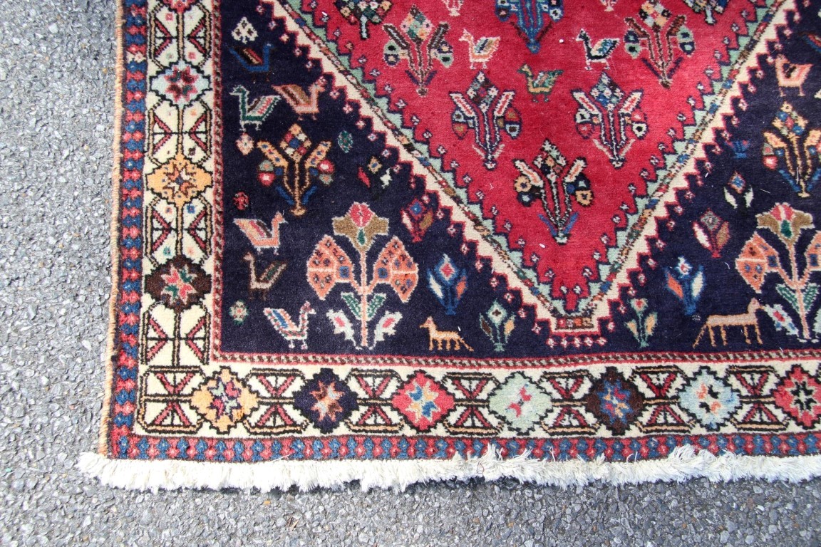 A Persian Qashgai rug, with central medallion and stylised flowers, birds and four horse heads, - Image 7 of 16