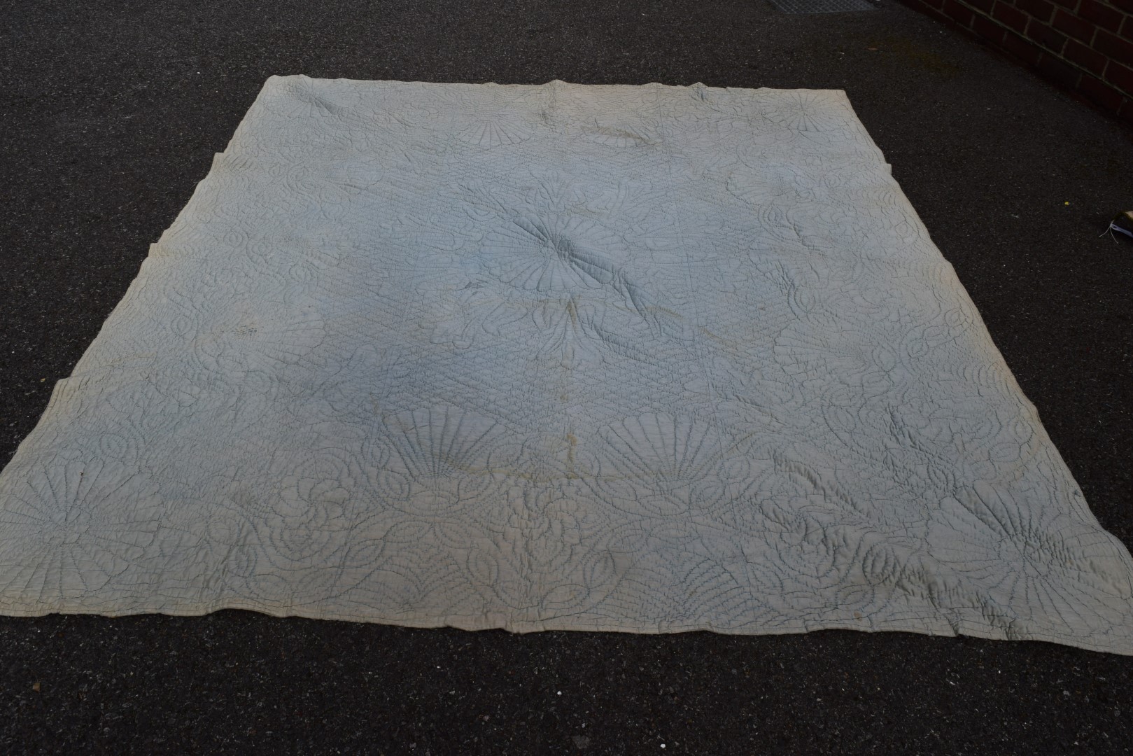 An early 20th century Durham quilt with large central medallion, 2343 x 204cm.