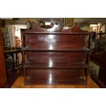 A George IV mahogany four tier hanging wall shelf, 84cm wide.