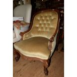 A Victorian carved walnut and button upholstered nursing chair.