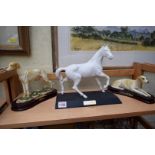 A Beswick 'Spirit of the Wind' figure; together with two other figures of dogs.