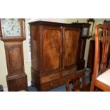 A George III mahogany linen press, the pair of panelled doors enclosing five oak sliding trays,