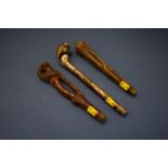 Two carved and pierced horn parasol handles, possibly rhinoceros,