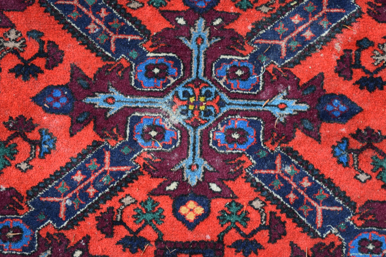 A Caucasian Seychour rug, with large cross design on red floral field, 178 x 123cm.