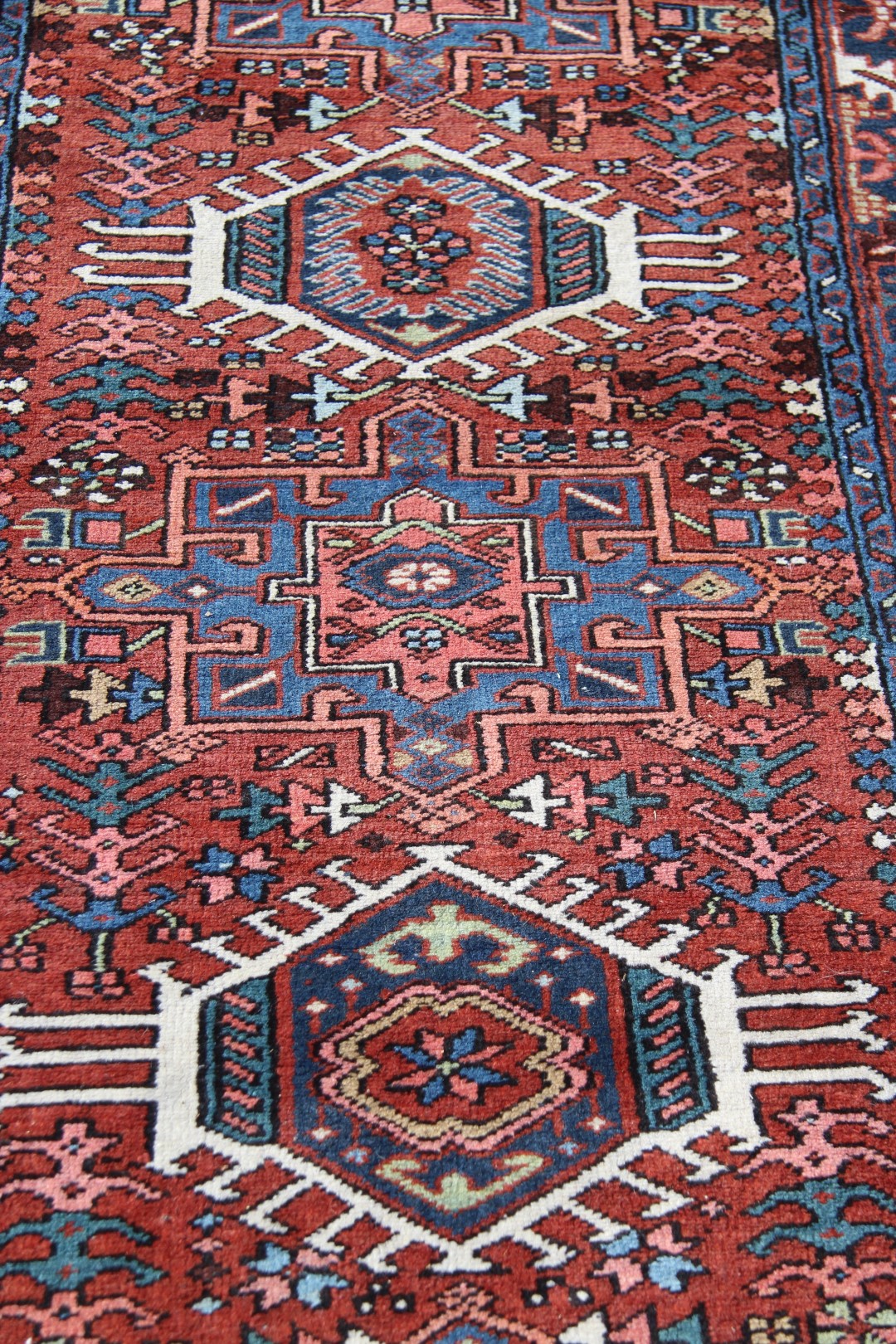 A North West Persian Karaja runner, with seven medallions on a geometric design red field, - Image 9 of 18