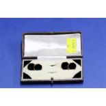 A cased pair of onyx set 9ct gold cufflinks, 9.8g in total.