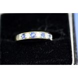 An 18ct gold inline sapphire and diamond ring.