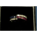 A triple row full eternity ring, the central row pave set half sapphires and half rubies,
